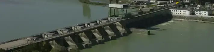 Aerial view of a run-of-river power plant located in a rural setting.