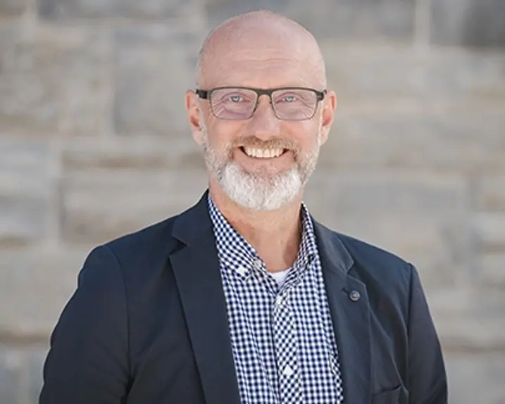 Rainer Tschopp wears a blue checked shirt, a blazer and a smile.